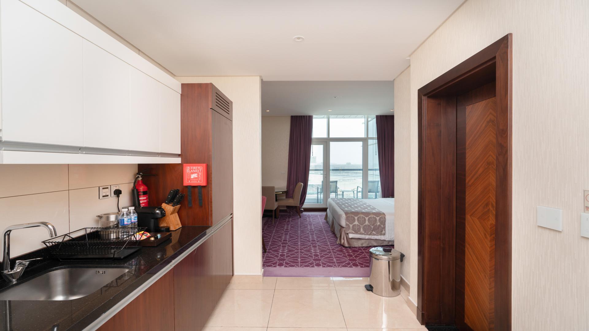 Elegantly furnished studio apartment interior with balcony view in Business Bay, Royal Continental Suites