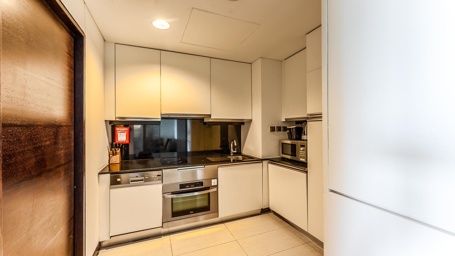 Luxurious Dubai Marina apartment bedroom with modern furnishings, JW Marriott Hotel sub-community