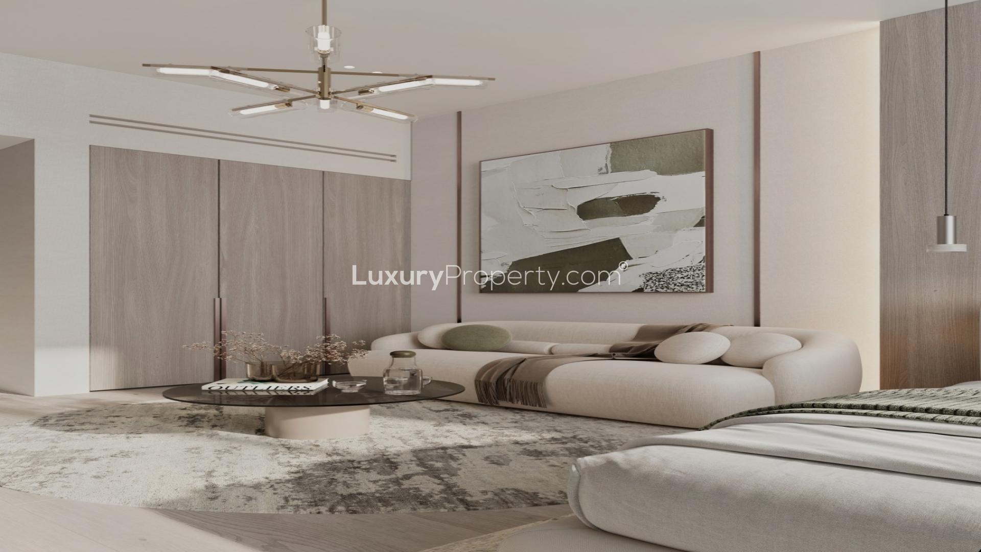 Modern kitchen and living area in Cove Grand apartment, Dubai Land Residence Complex