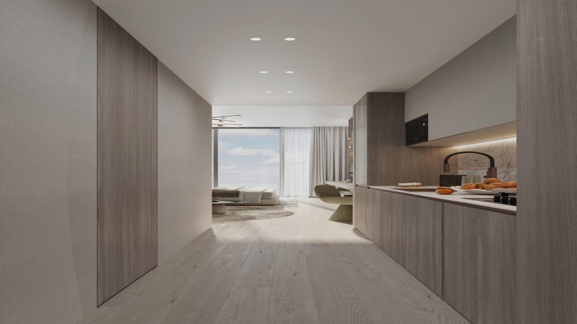 Modern kitchen in Cove Grand apartment, Dubai Land Residence Complex, featuring sleek cabinetry and lighting