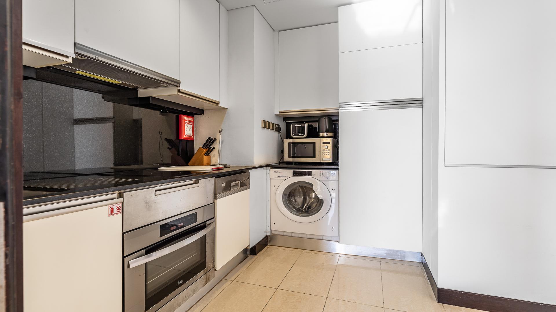 "Stunning view of Dubai Marina from JW Marriott Hotel Marina apartment balcony, LP47961 sale.",Compact kitchen with modern appliances in Dubai Marina apartment for sale, JW Marriott Hotel area