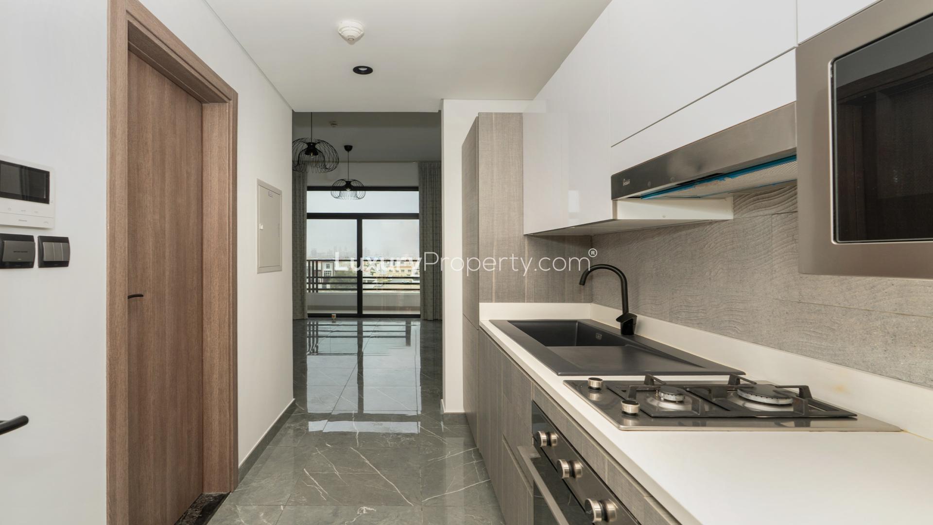 Studio apartment interior at Joya Blanca Residences, Arjan, with large window and modern finishes
