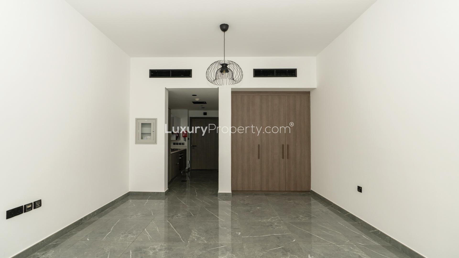 Modern kitchen in studio apartment, Joya Blanca Residences, Arjan, with sleek cabinetry and appliances