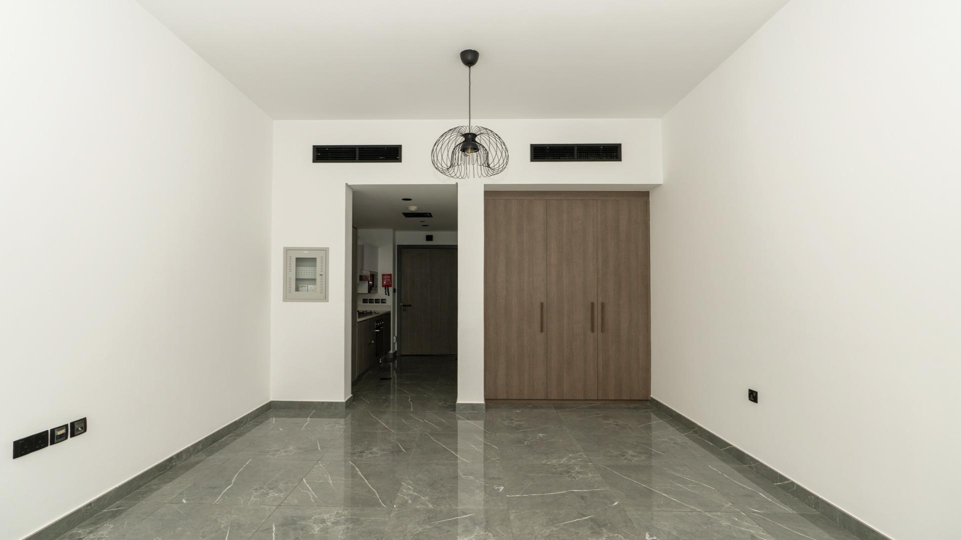 Modern kitchen in studio apartment, Joya Blanca Residences, Arjan, with sleek cabinetry and appliances