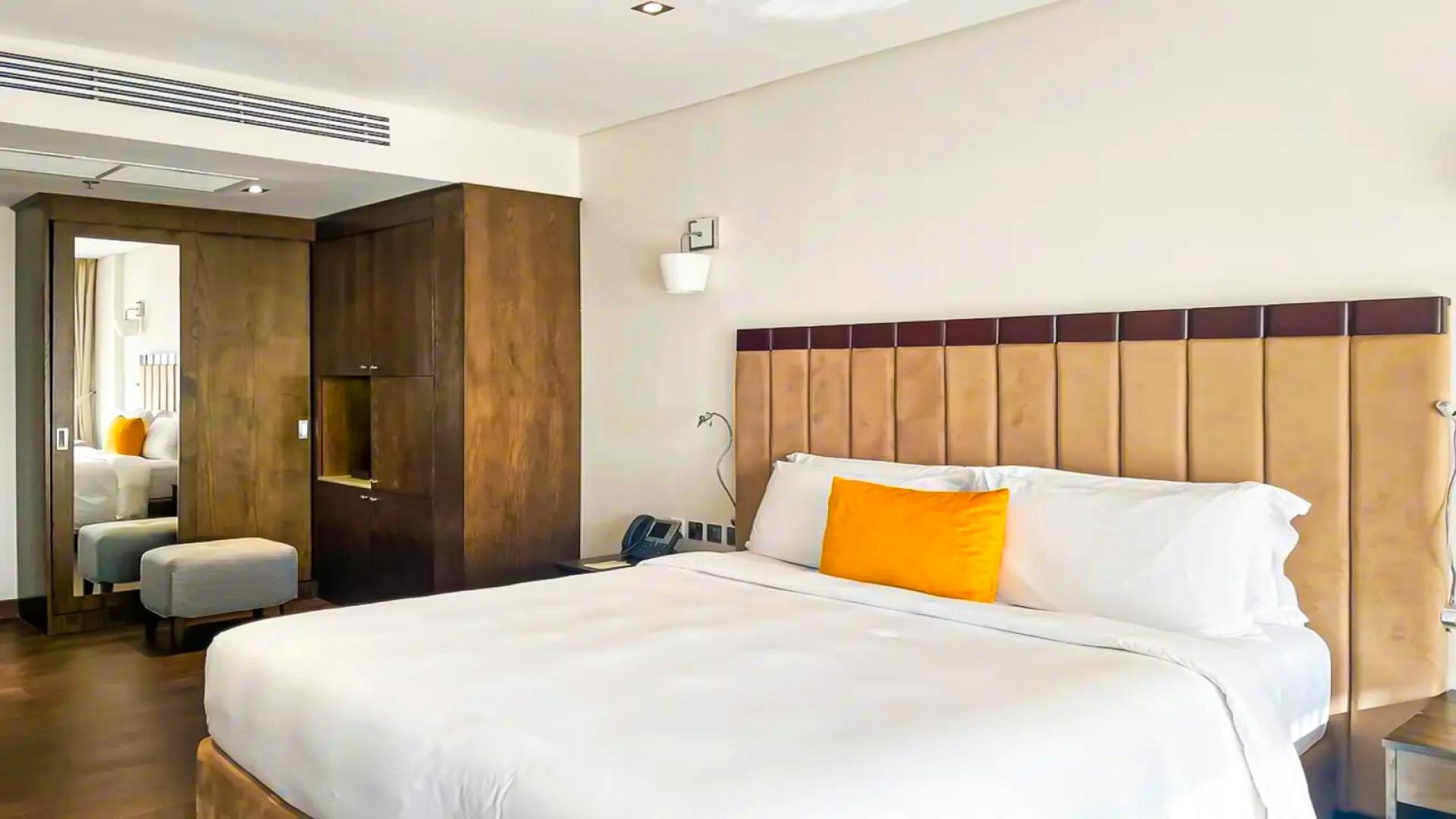 Studio bedroom in Royal Amwaj Residences, Palm Jumeirah, with modern decor and wooden accents