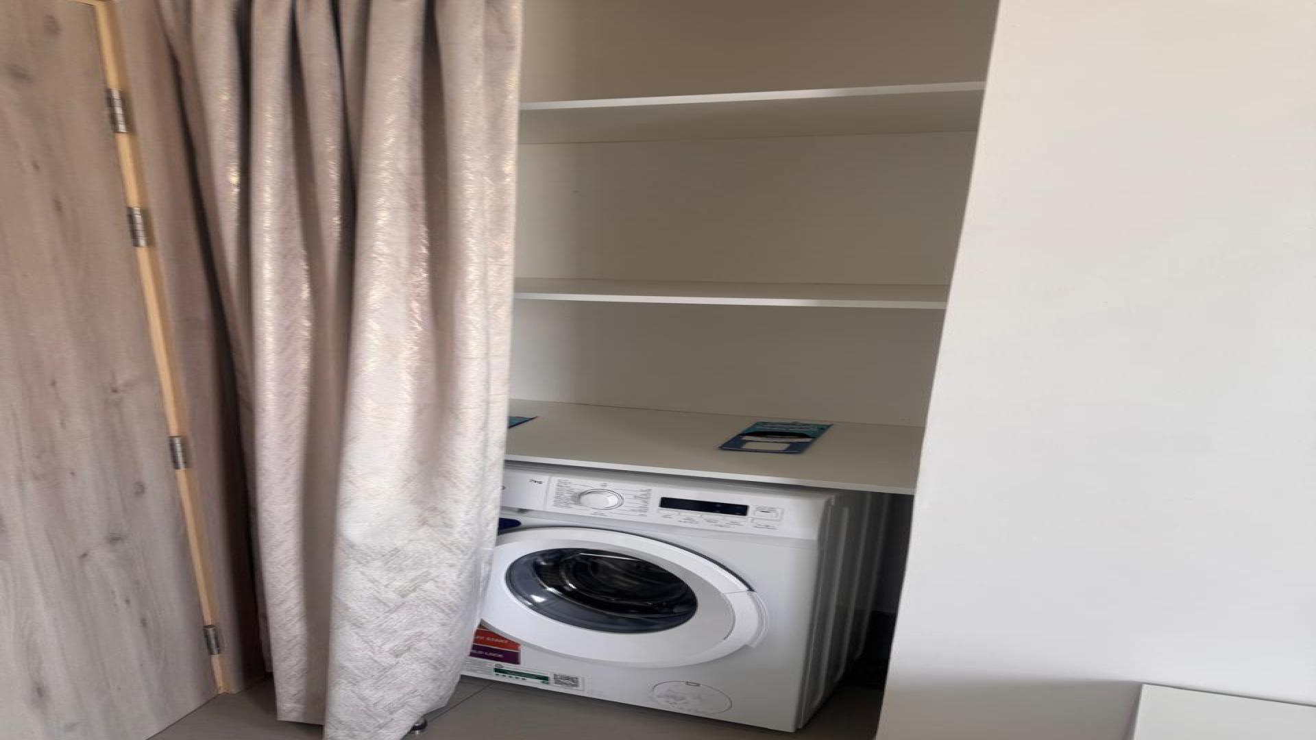 Modern kitchen in Prive Residence apartment, Dubai Hills Estate, featuring sleek appliances and cabinetry