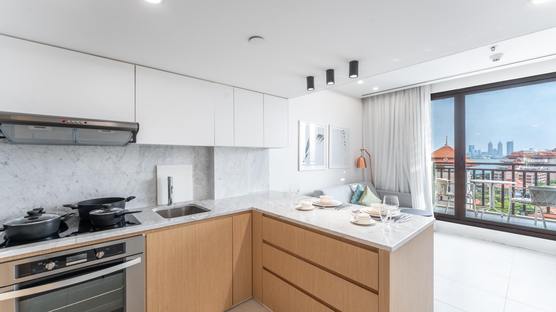 Modern kitchen in Palm Jumeirah penthouse studio, Anantara Residences, with marble countertops