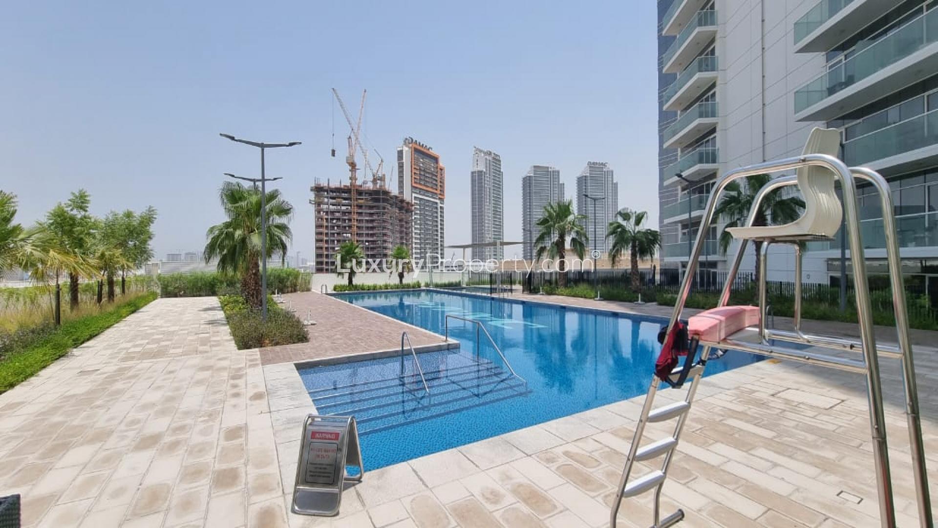 Modern bathroom in studio apartment, Artesia, Damac Hills, featuring bathtub and sleek fixtures