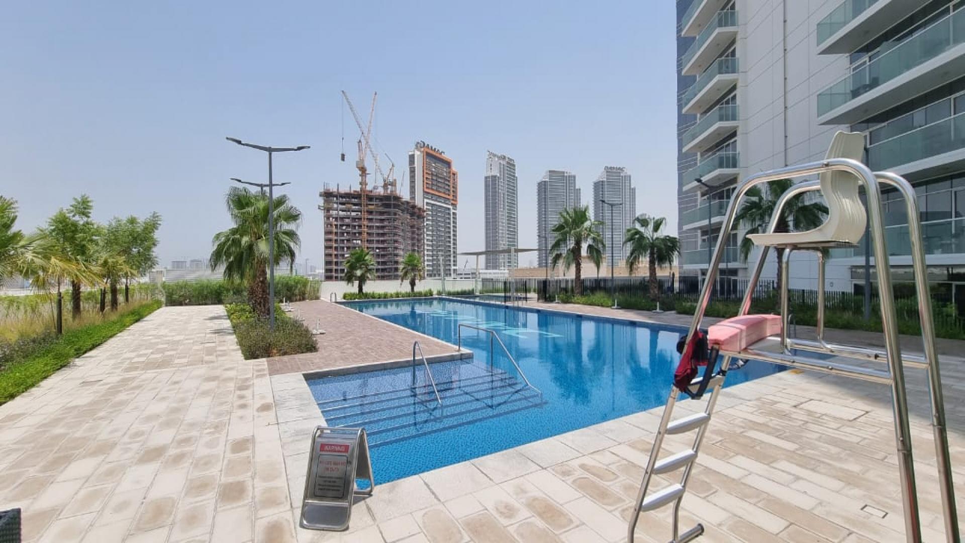 Modern bathroom in studio apartment, Artesia, Damac Hills, featuring bathtub and sleek fixtures
