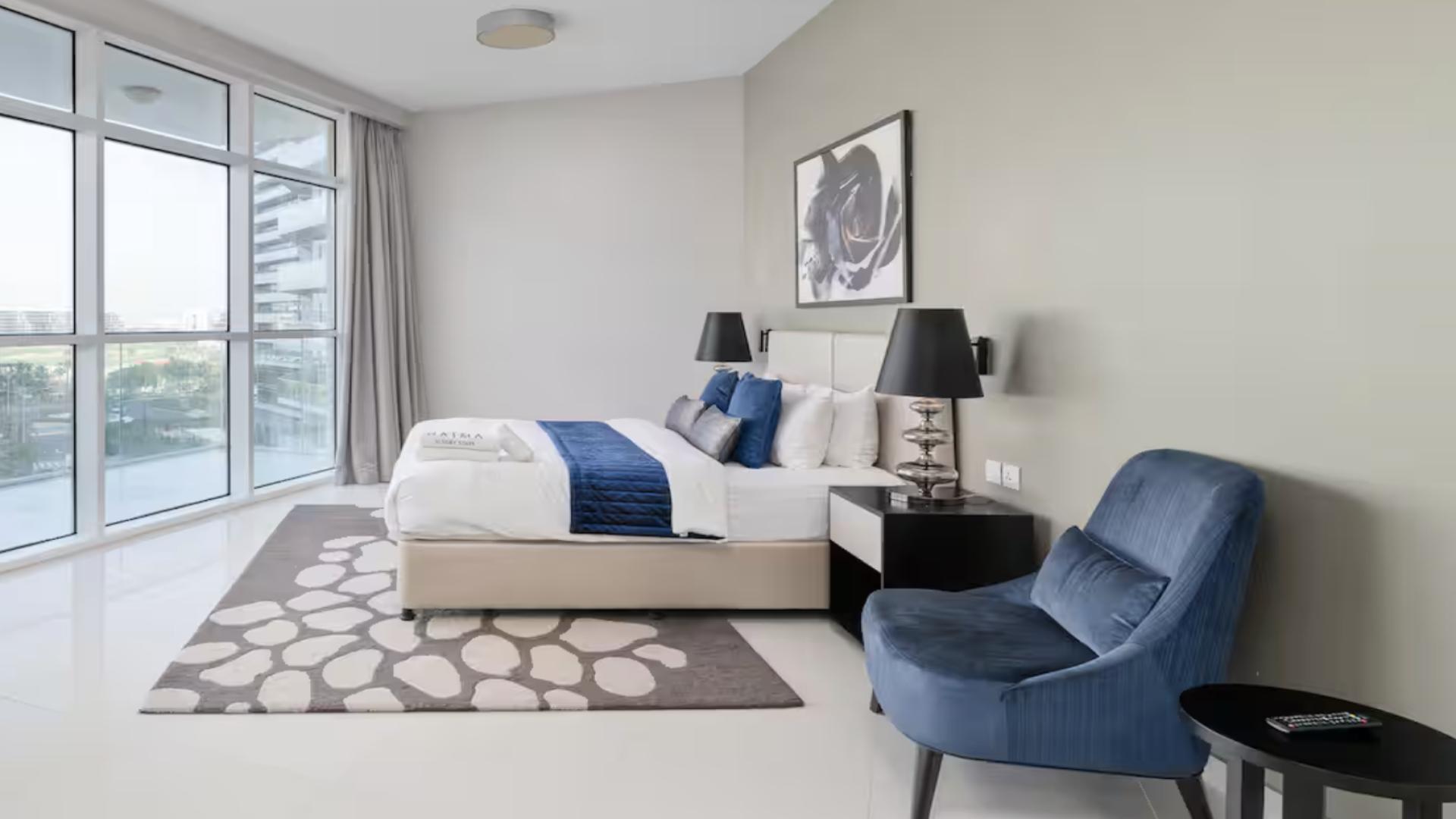 Modern studio apartment with large windows and stylish furnishings in Artesia, Damac Hills