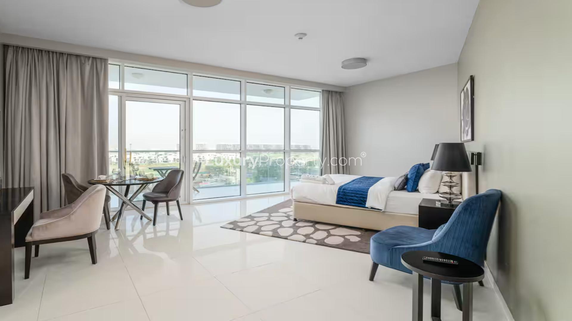 Luxurious bedroom in Artesia apartment, Damac Hills, featuring modern decor and large windows