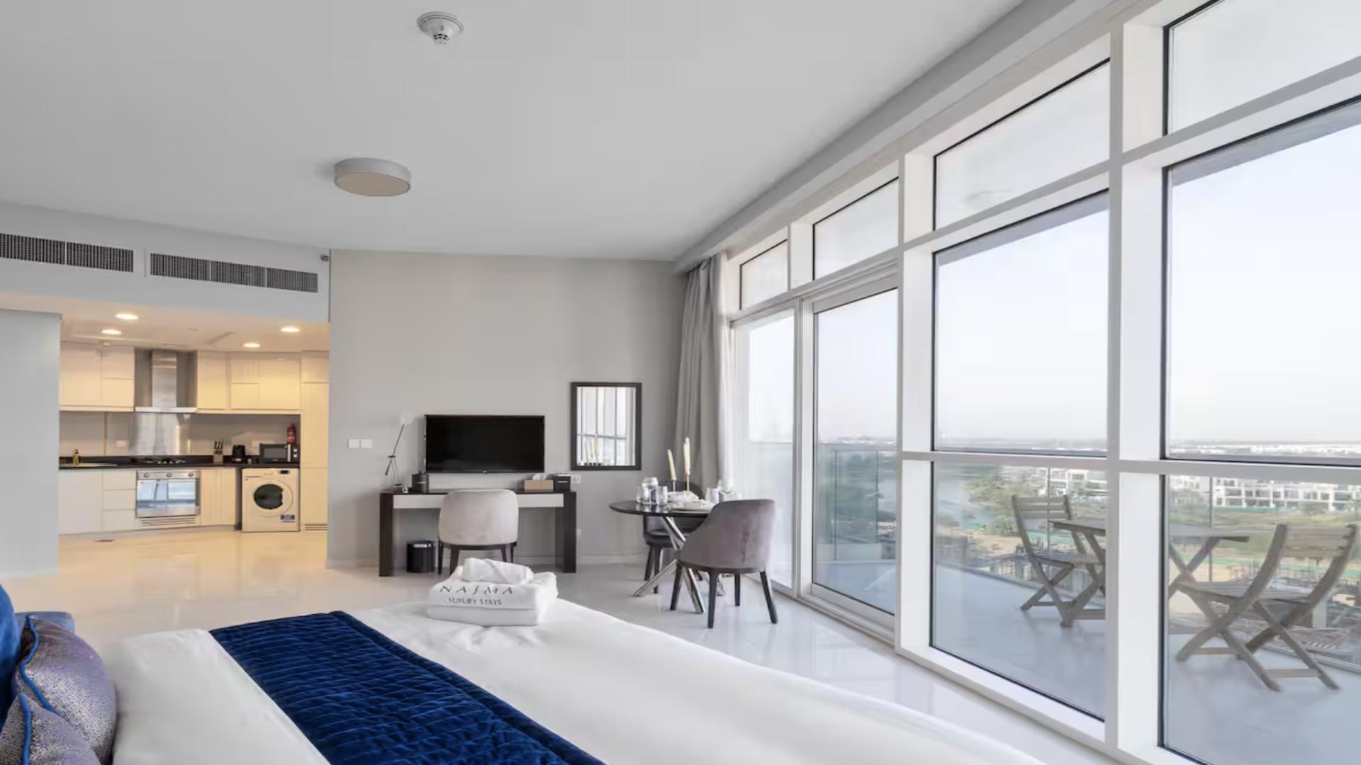 Modern furnished apartment bedroom with large windows in Artesia, Damac Hills, for sale