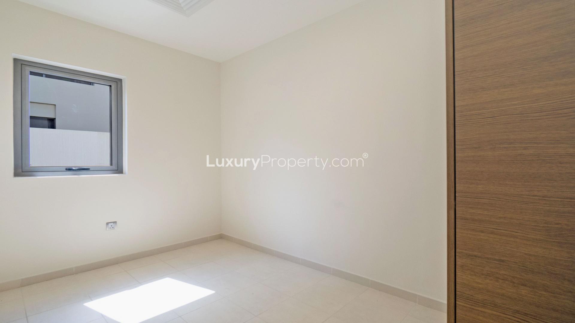 Open-plan kitchen and living area in Sidra Villas, Dubai Hills Estate. Elegant design and spacious layout