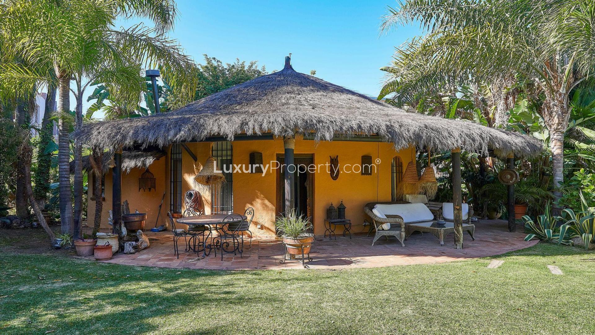 Charming villa with thatched roof patio in Atalaya de Río Verde, Marbella garden setting
