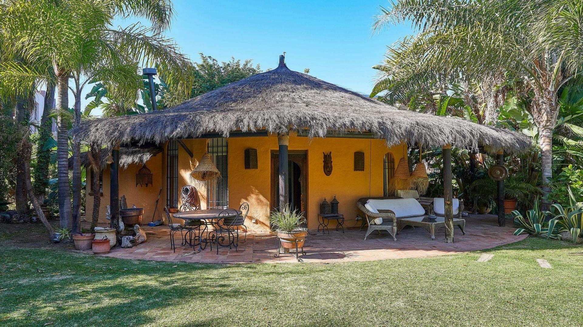 Charming villa with thatched roof patio in Atalaya de Río Verde, Marbella garden setting
