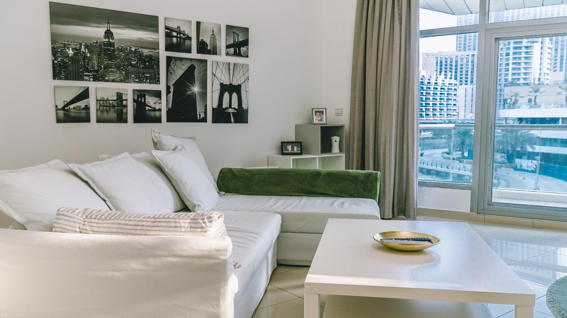 Modern living room in Park Island apartment, Dubai Marina, with large windows and TV