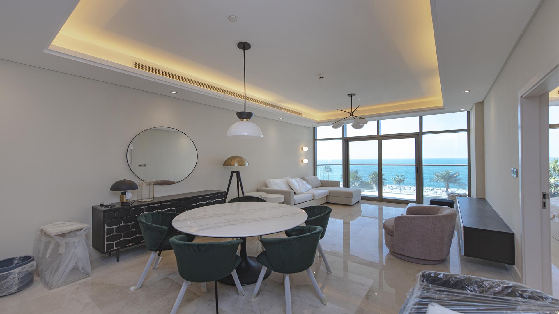 "Sea view from one-bedroom apartment balcony in The 8, Palm Jumeirah, for sale.",Luxurious Palm Jumeirah apartment with sea view, modern living room, and elegant furnishings