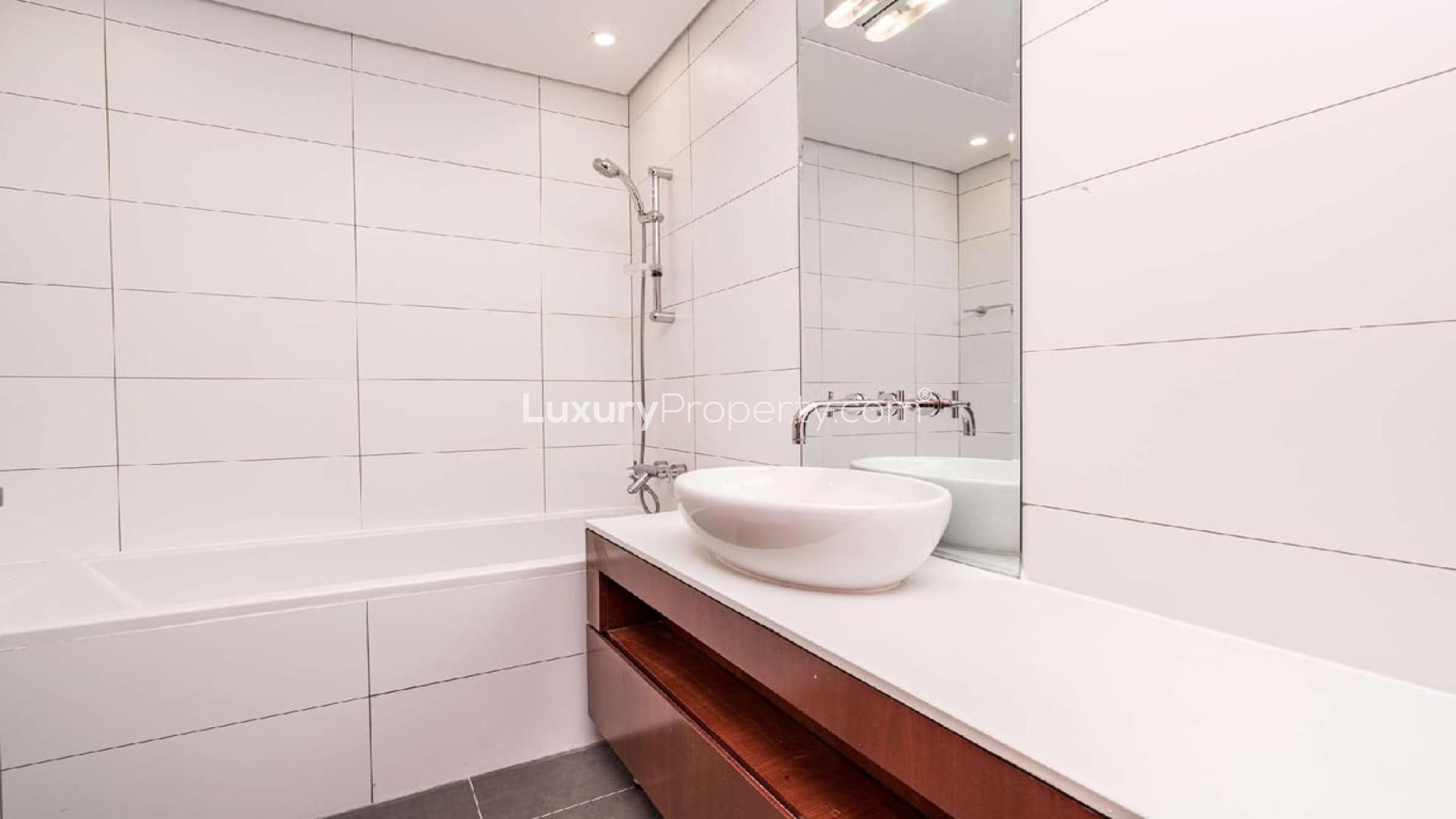 Empty 1-bedroom apartment with city view in Maze Tower, DIFC, featuring wood accents