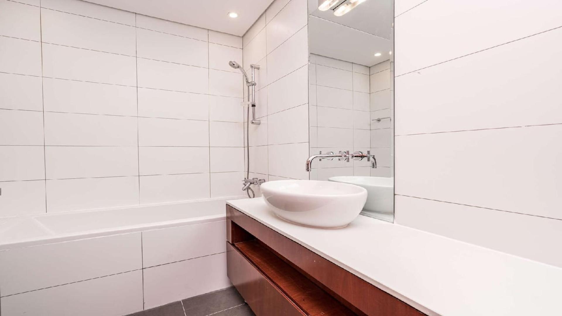 Empty 1-bedroom apartment with city view in Maze Tower, DIFC, featuring wood accents