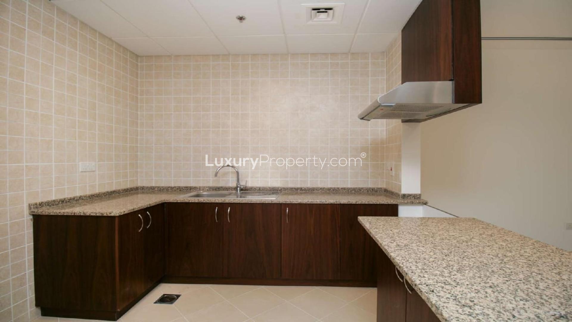 Balcony view of beachfront apartment in Sarai Apartments, Palm Jumeirah, overlooking palm trees and pool