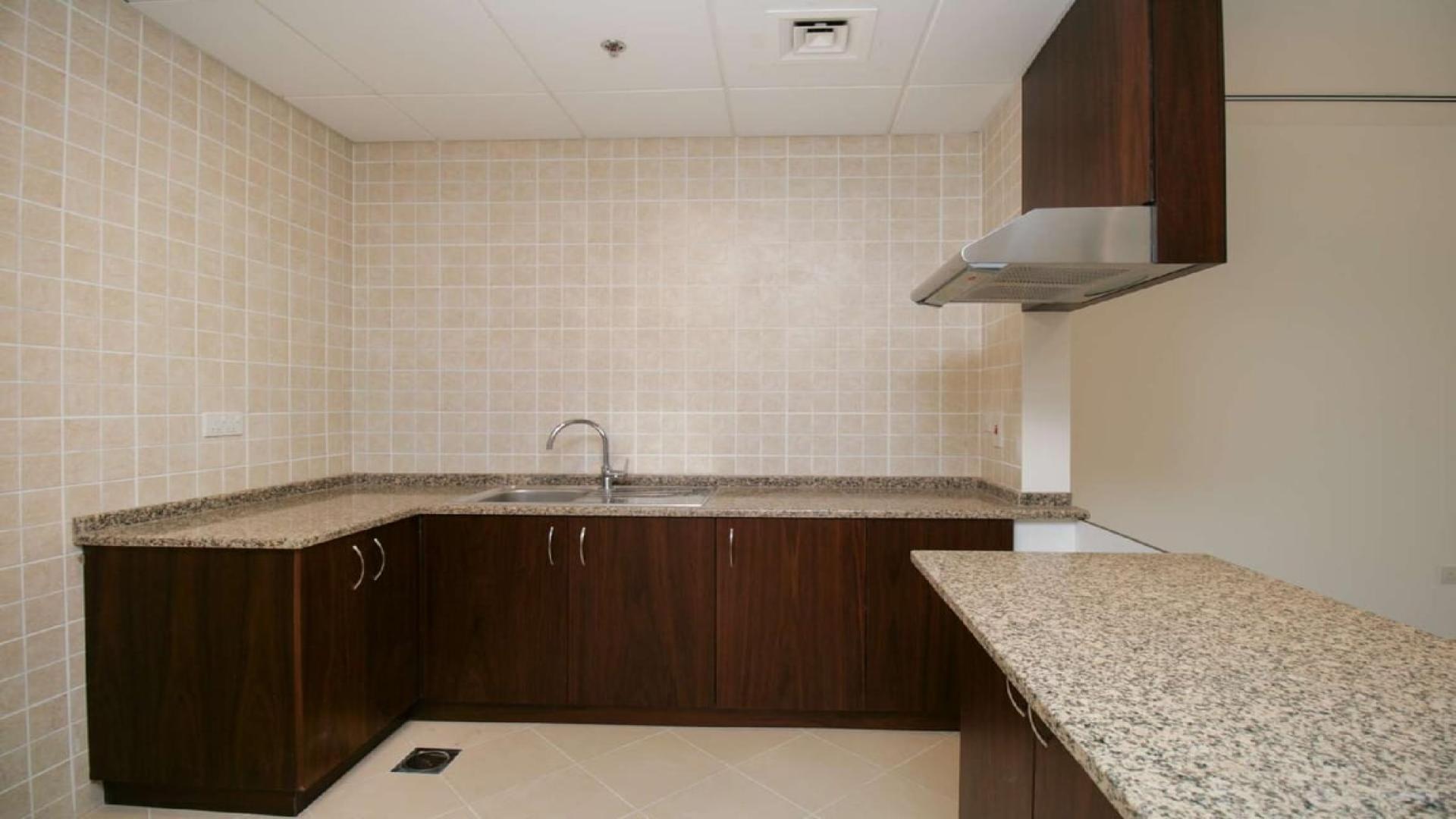 Balcony view of beachfront apartment in Sarai Apartments, Palm Jumeirah, overlooking palm trees and pool