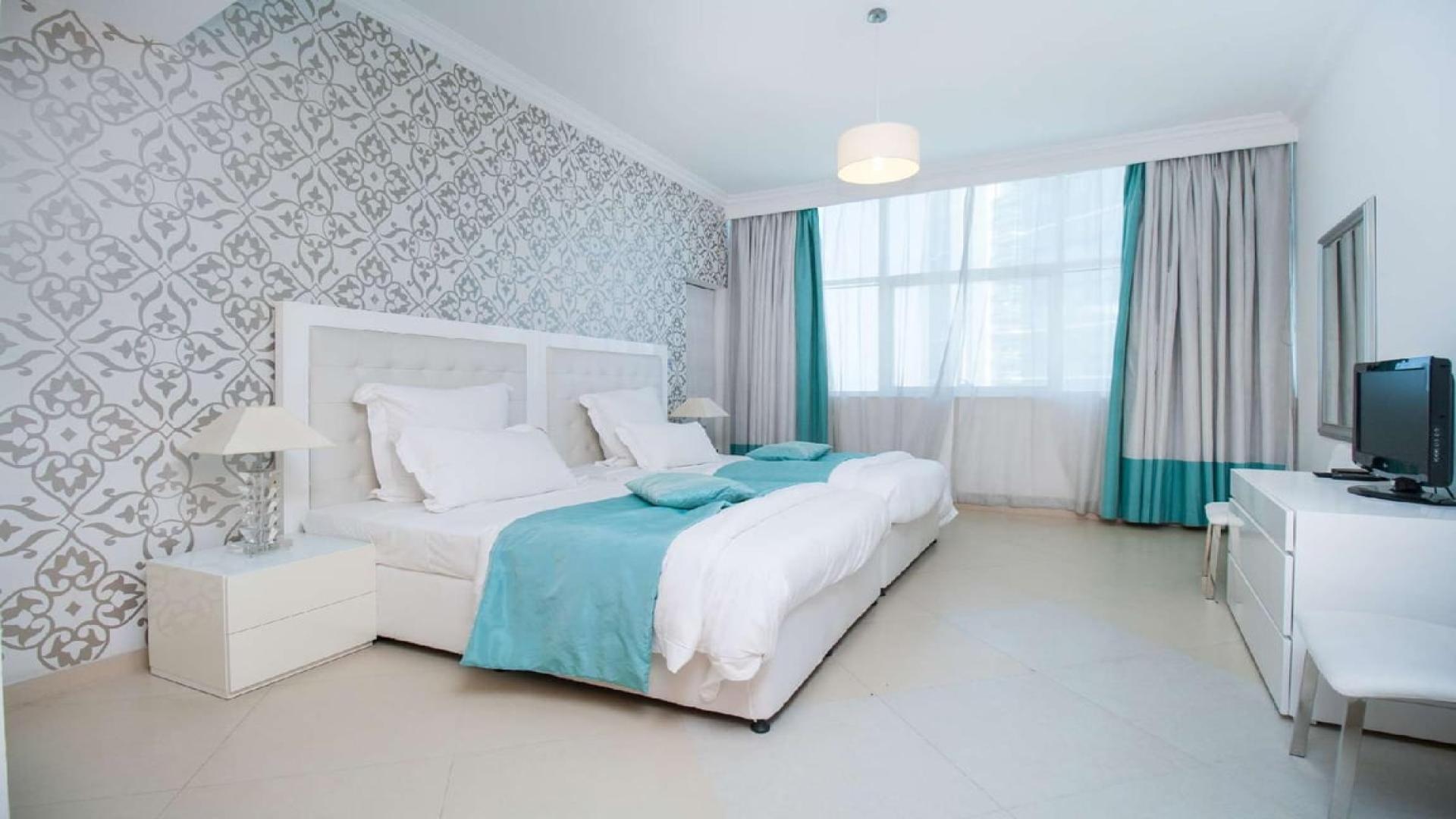 Modern living room in Dorra Bay apartment, Dubai Marina, featuring elegant decor and natural light