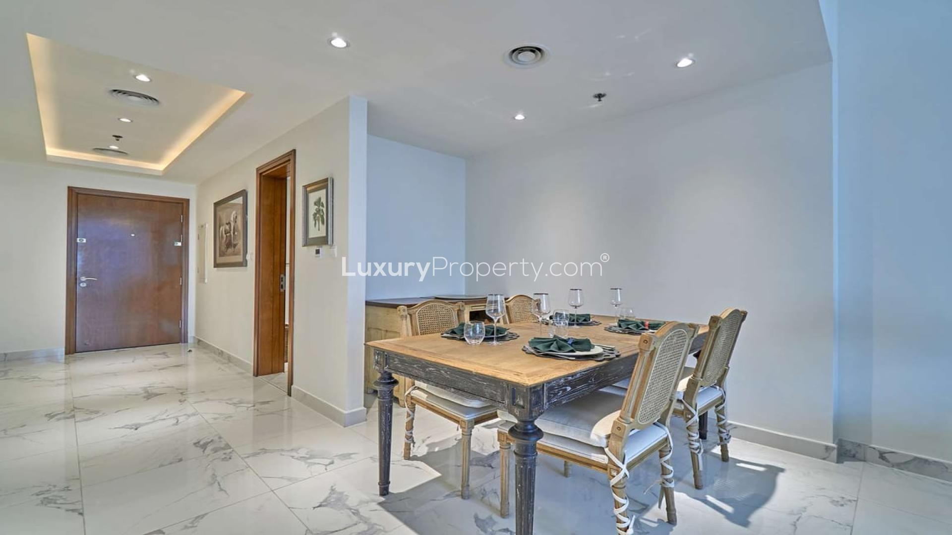 "Modern living room in Amna Tower apartment, Business Bay, with city views and elegant decor.",Dining area in one-bedroom apartment, Amna Tower, Al Habtoor City, Business Bay, for rent