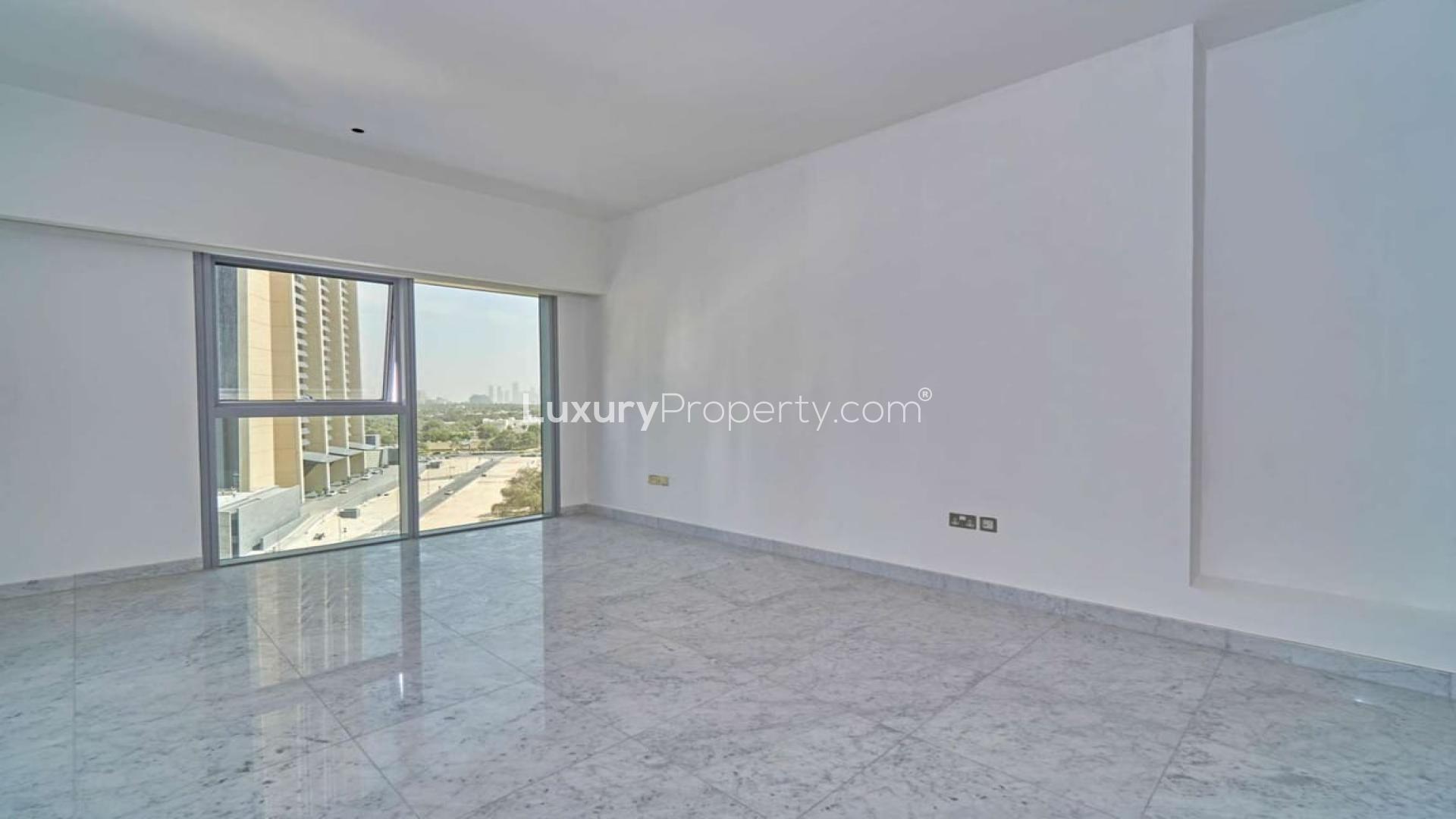 Empty living room with large window in DIFC apartment, Central Park Tower