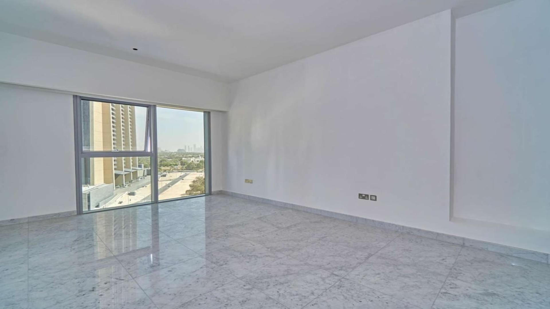 Empty living room with large window in DIFC apartment, Central Park Tower
