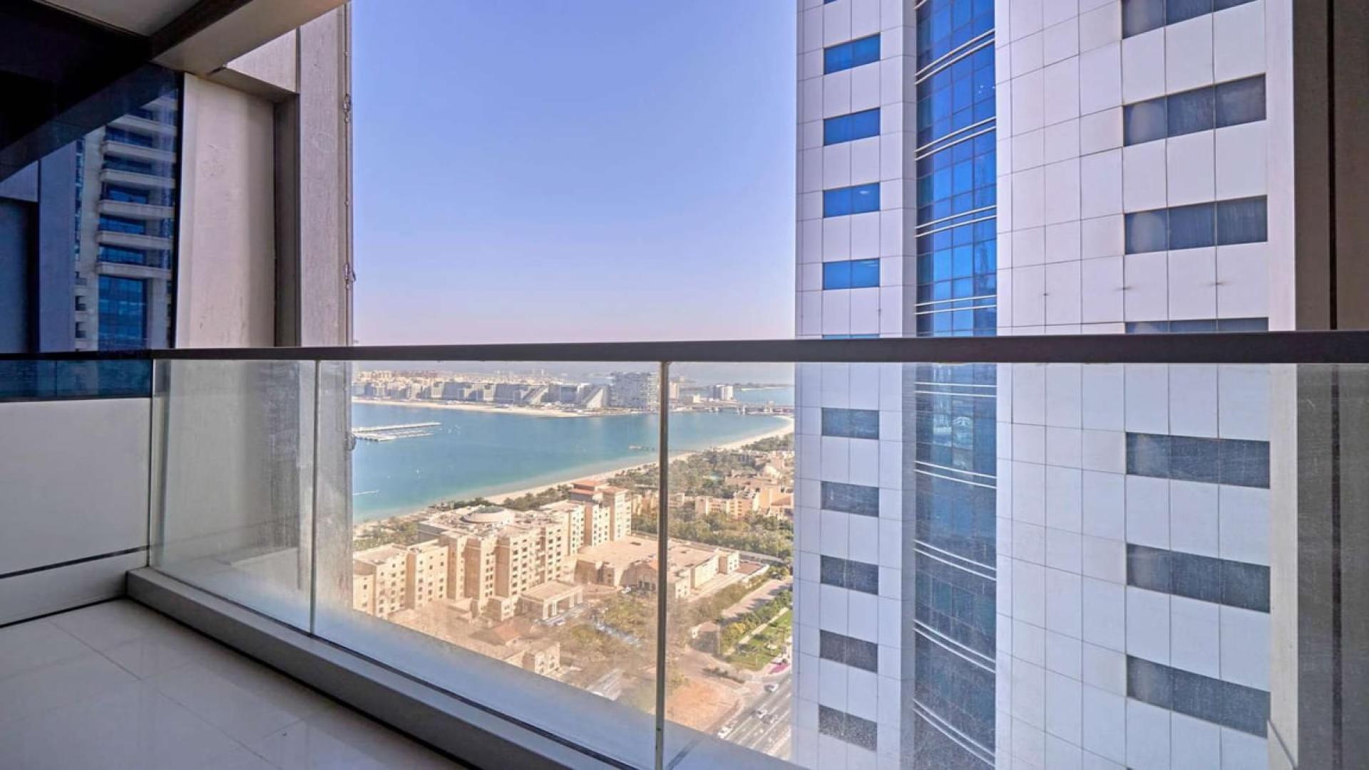Modern living room in Ocean Heights 1-bedroom apartment, Dubai Marina, with large window view