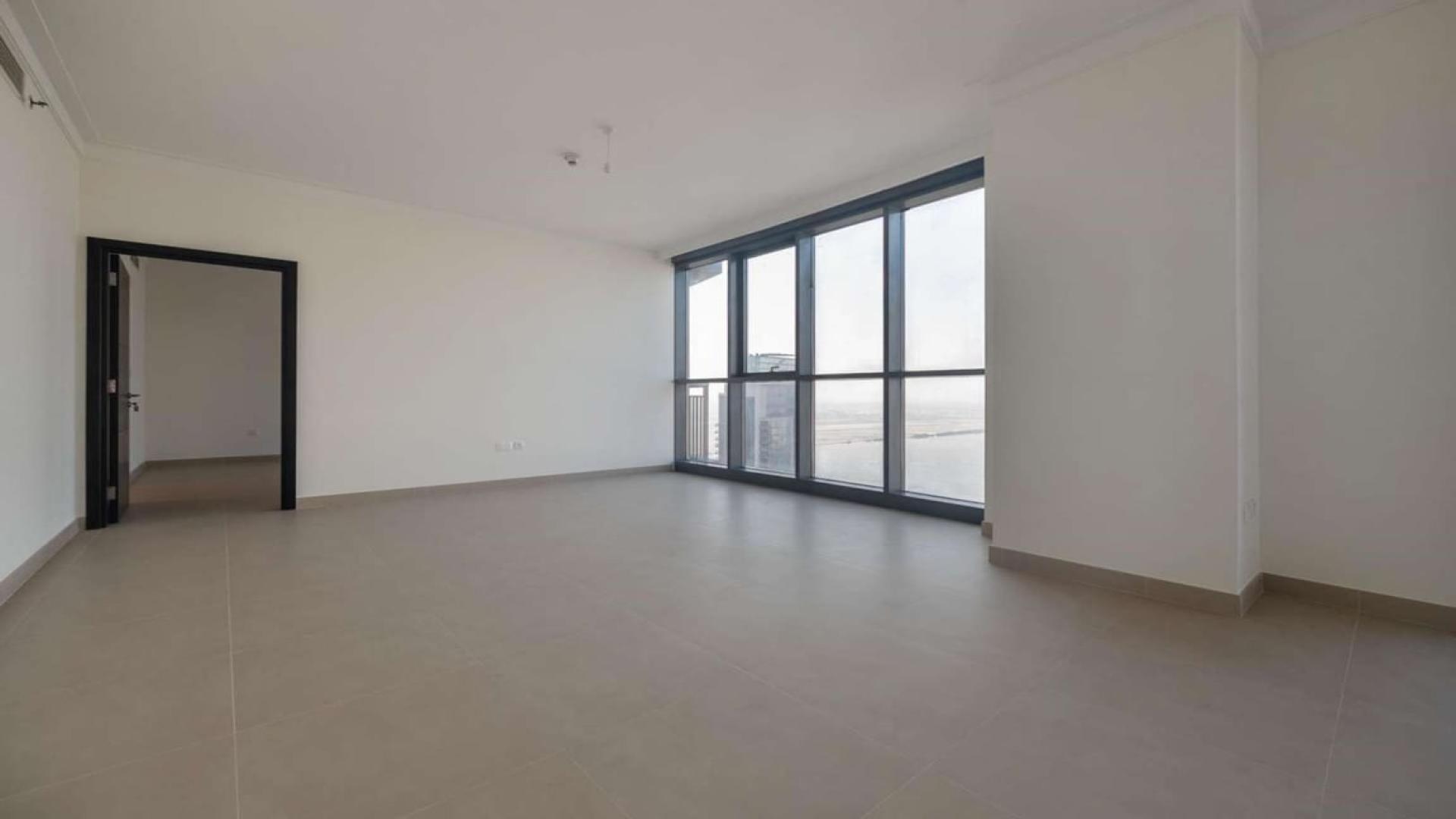Empty living room with large windows in Dubai Creek Harbour apartment