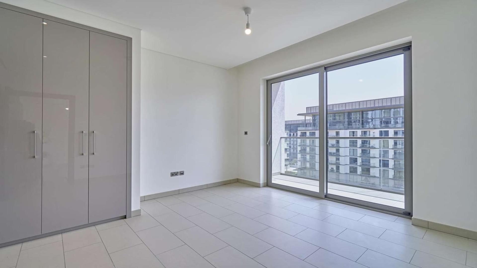 Brightly lit apartment interior with large windows in Sobha Hartland, Mohammed Bin Rashid City