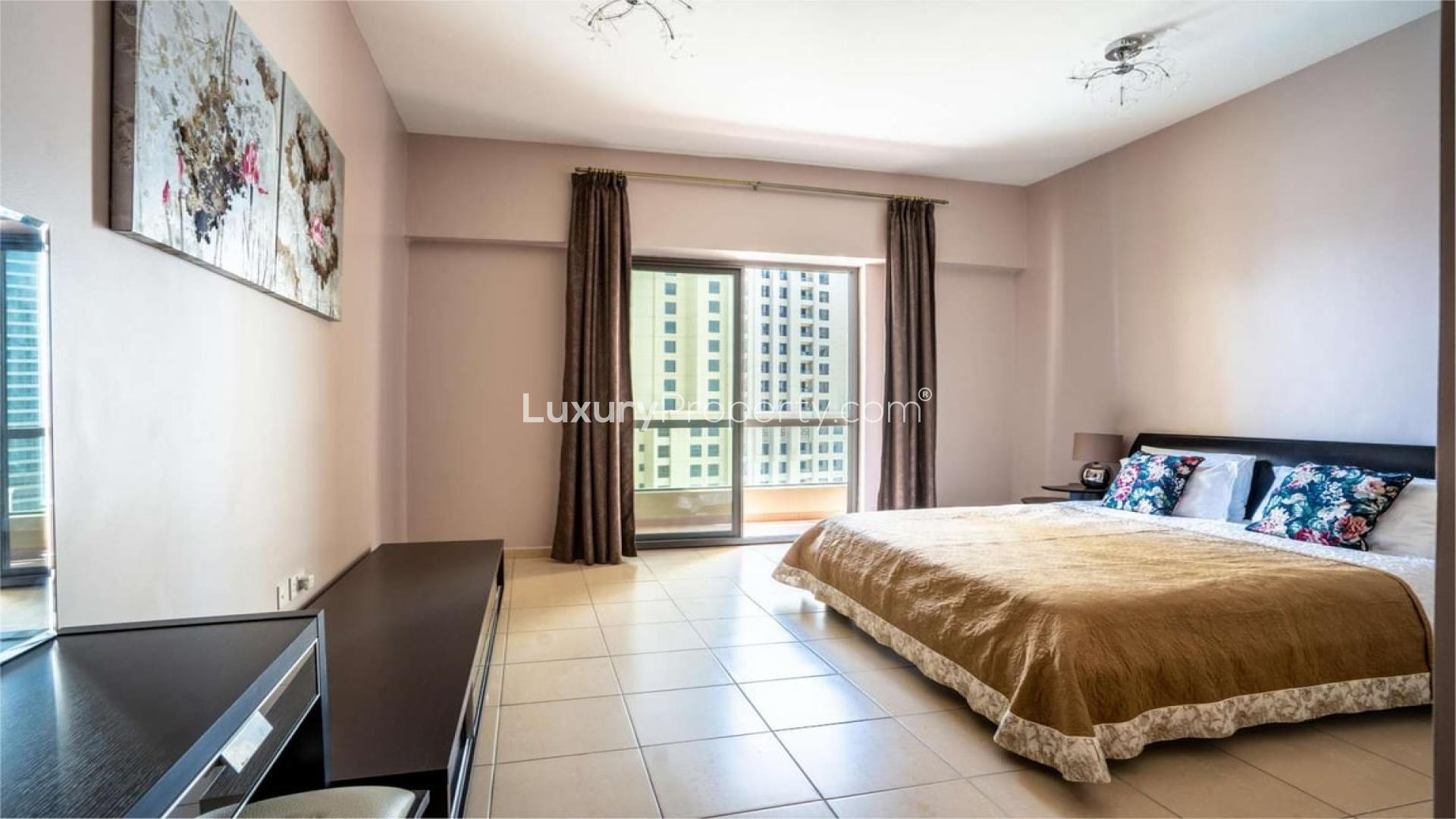 Balcony view from one-bedroom apartment in Sadaf, Jumeirah Beach Residence overlooking marina skyline