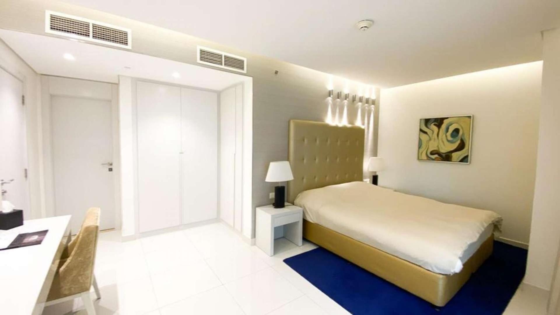 Luxurious bedroom in The Vogue apartment, Business Bay with modern decor and stylish furnishings