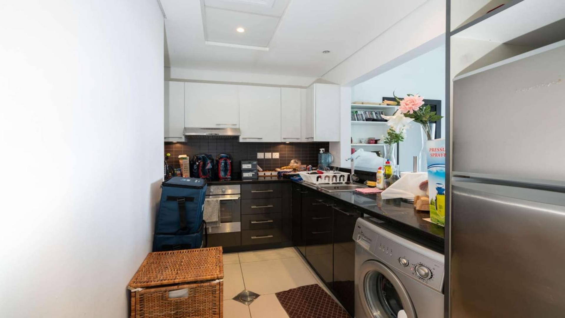 "Dubai Marina view from Silverene Tower B apartment, showcasing waterfront skyline and yachts.",Modern kitchen in one-bedroom apartment, Silverene Tower B, Dubai Marina, available for rent