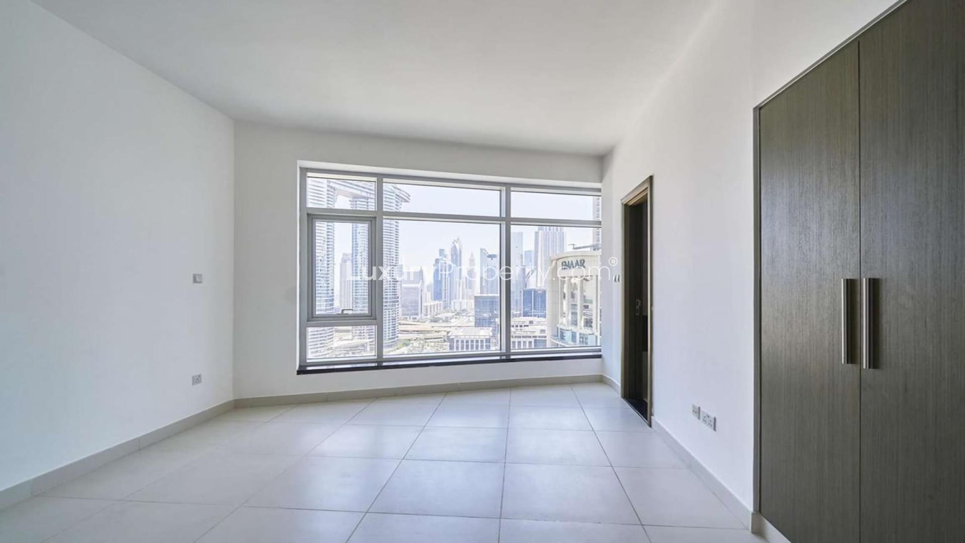 Bright living room with large windows, city views in Downtown Dubai apartment for rent