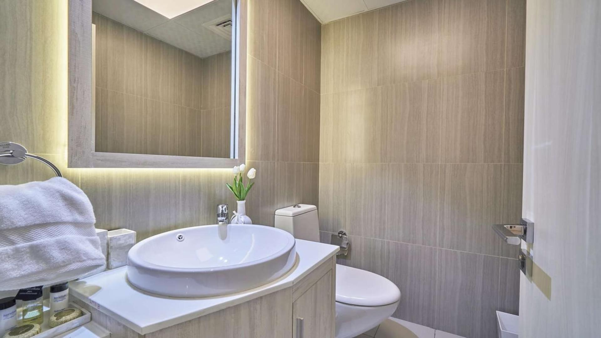 Modern kitchen and living area in Jumeirah Village Circle 1-bedroom apartment for rent