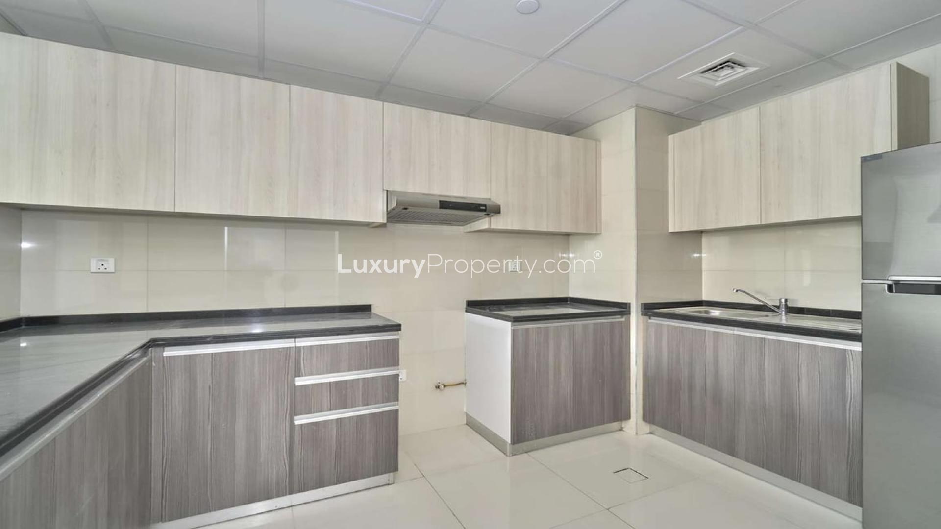 Bright living room in Jumeirah Village Circle apartment, large windows, modern design