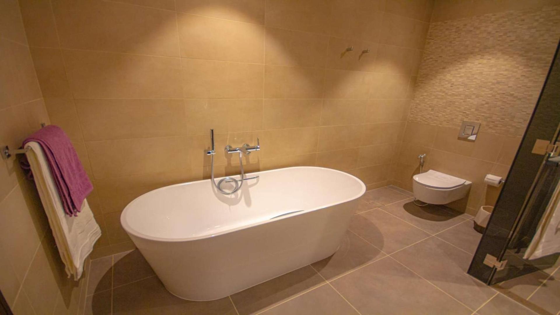 Modern open-plan kitchen and dining area in Jumeirah Living Marina Gate apartment, Dubai Marina