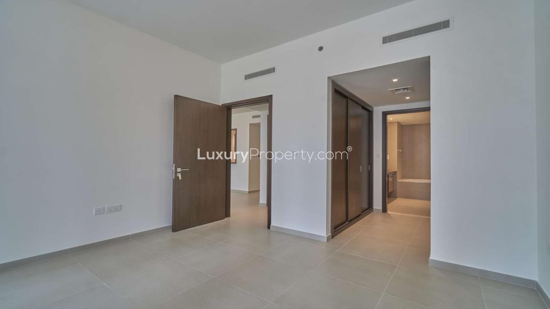 Empty living room with large windows in Boulevard Heights apartment, Downtown Dubai