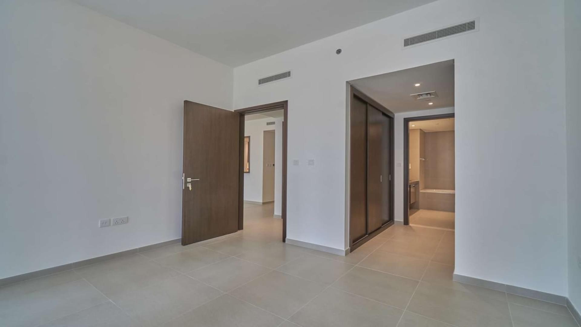 Empty living room with large windows in Boulevard Heights apartment, Downtown Dubai
