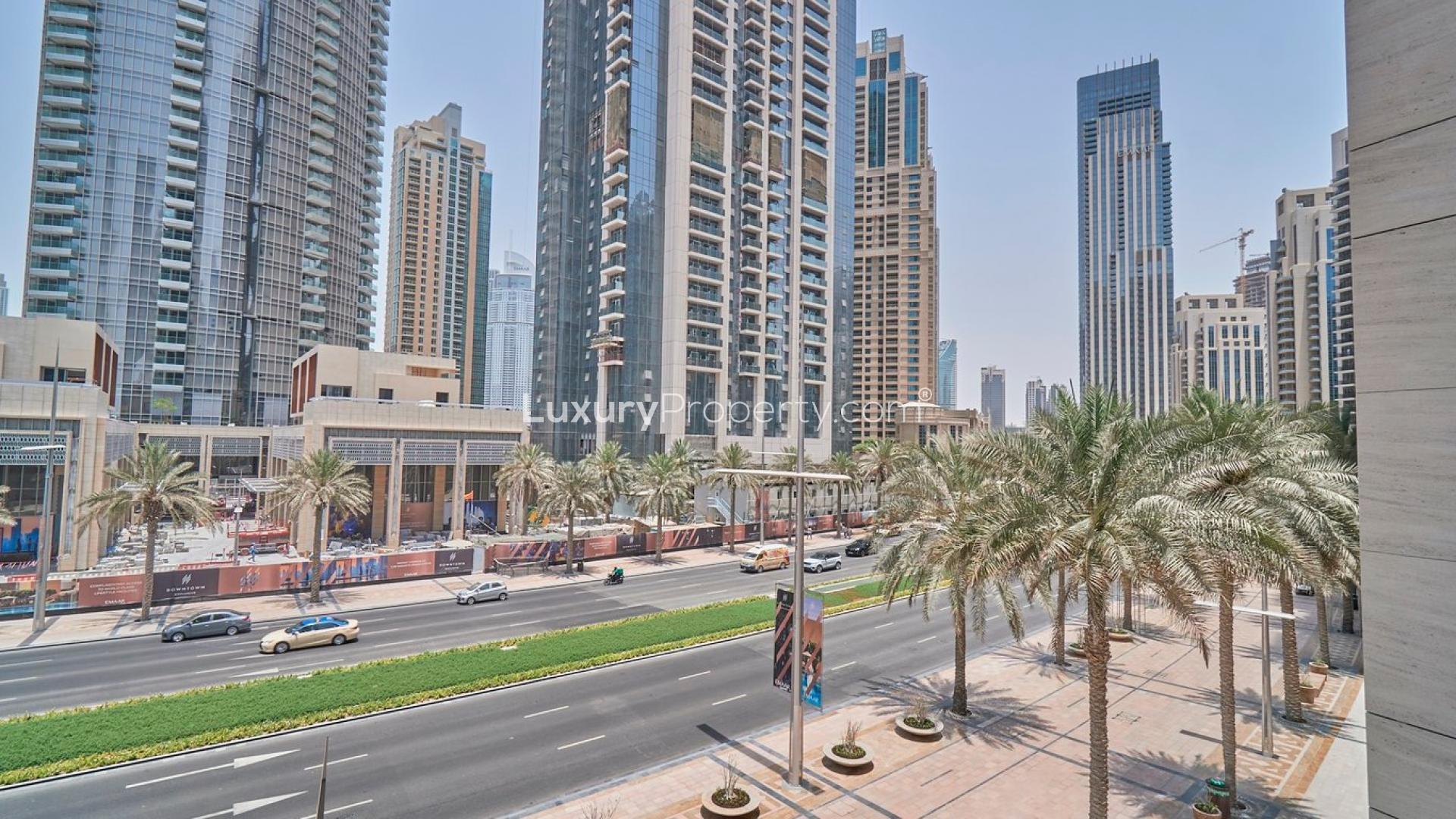 "Spacious balcony view from one-bedroom apartment in BLVD Heights, Downtown Dubai for rent.","Downtown Dubai Boulevard Heights view, showcasing high-rise apartments and bustling street with palm trees.",Balcony view from one-bedroom apartment in BLVD Heights, Downtown Dubai, showcasing cityscape