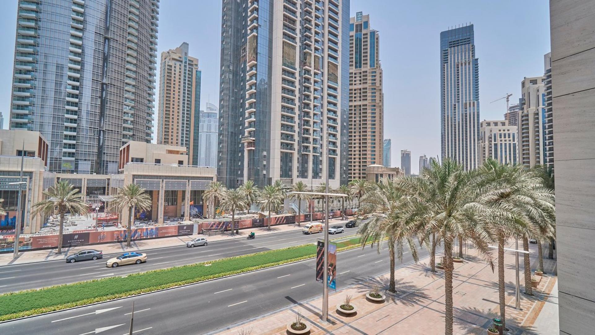 "Spacious balcony view from one-bedroom apartment in BLVD Heights, Downtown Dubai for rent.","Downtown Dubai Boulevard Heights view, showcasing high-rise apartments and bustling street with palm trees.",Balcony view from one-bedroom apartment in BLVD Heights, Downtown Dubai, showcasing cityscape
