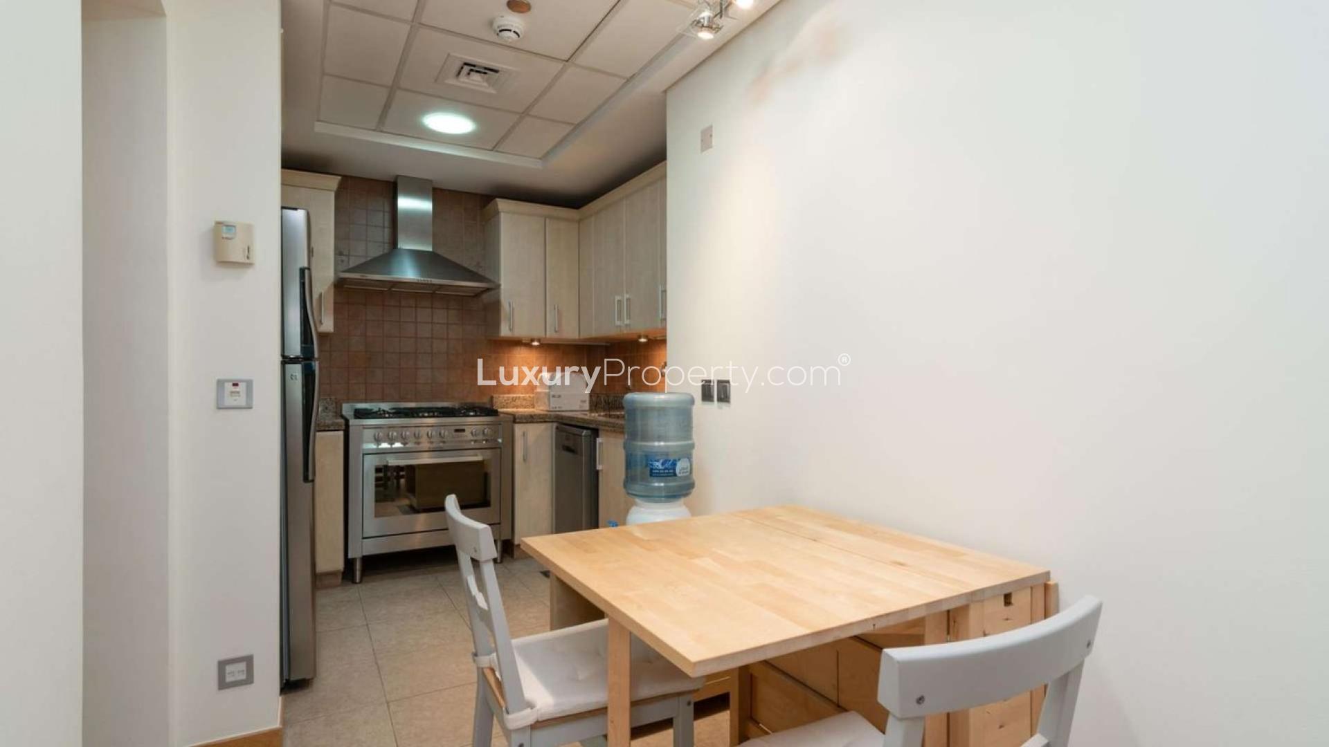 Compact kitchen with dining area in Shoreline Apartments, Palm Jumeirah rental unit