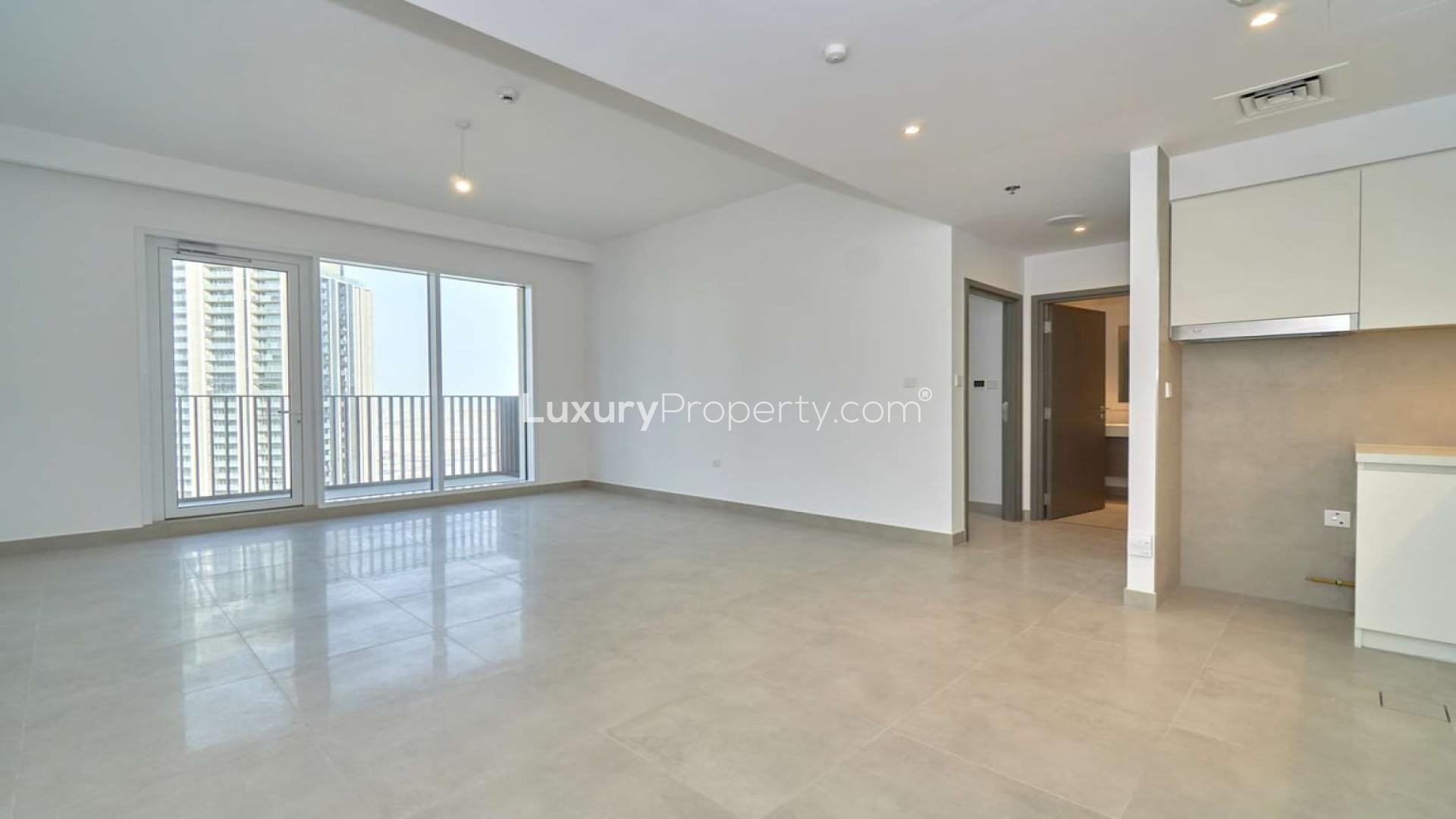 "Balcony view of modern skyscrapers from 1-bedroom apartment in Dubai Creek Harbour.",Brand new 1-bedroom apartment interior with large windows in Dubai Creek Harbour