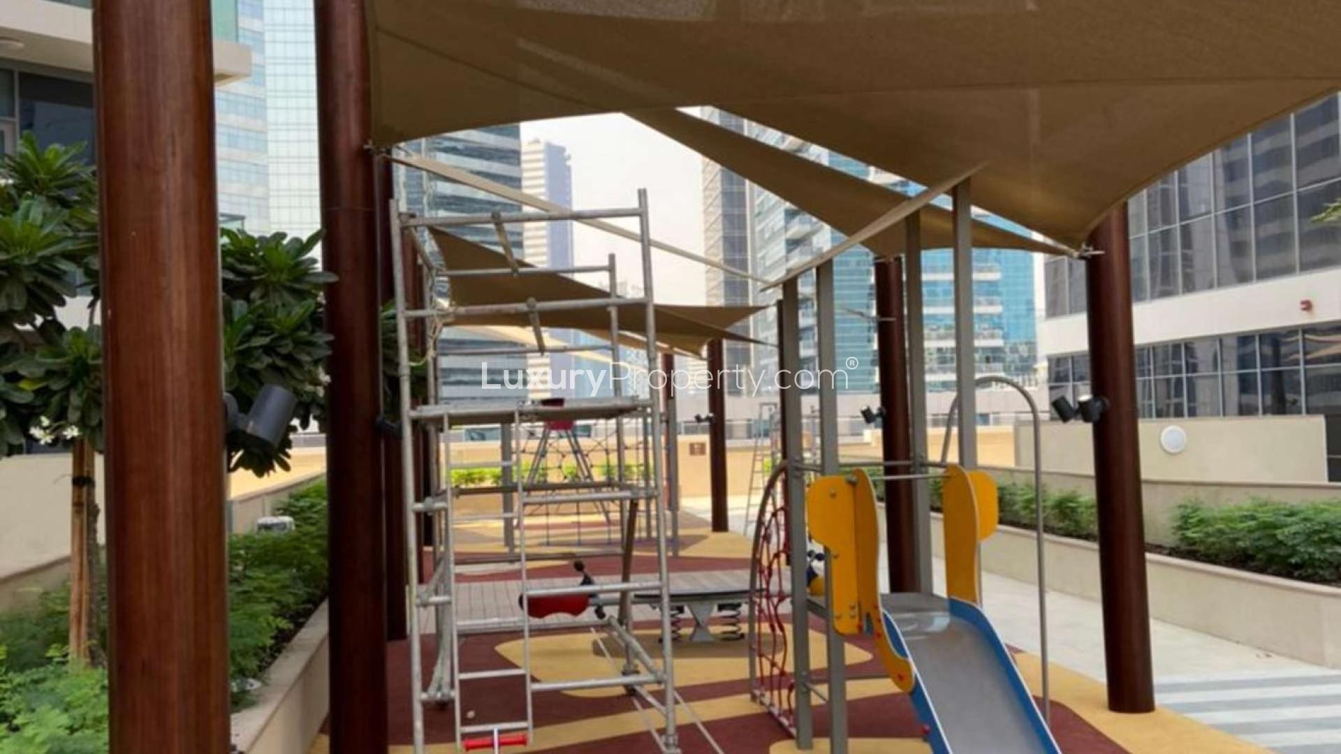 "View from Bellevue Towers apartment balcony overlooking Downtown Dubai skyline with Burj Khalifa.",Playground area at Bellevue Towers, Downtown Dubai, near brand new 1-bed apartment for rent