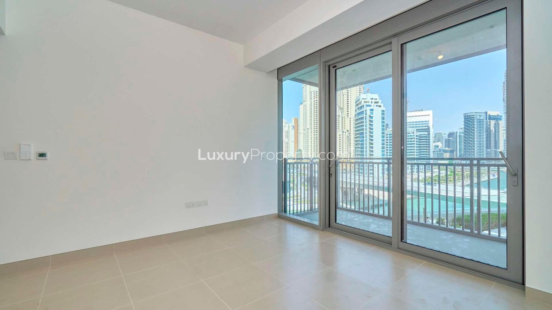 "Modern Dubai Marina apartment view with waterfront and cityscape, perfect for rent seekers.",Brand new Dubai Marina apartment with balcony view of skyline and waterfront