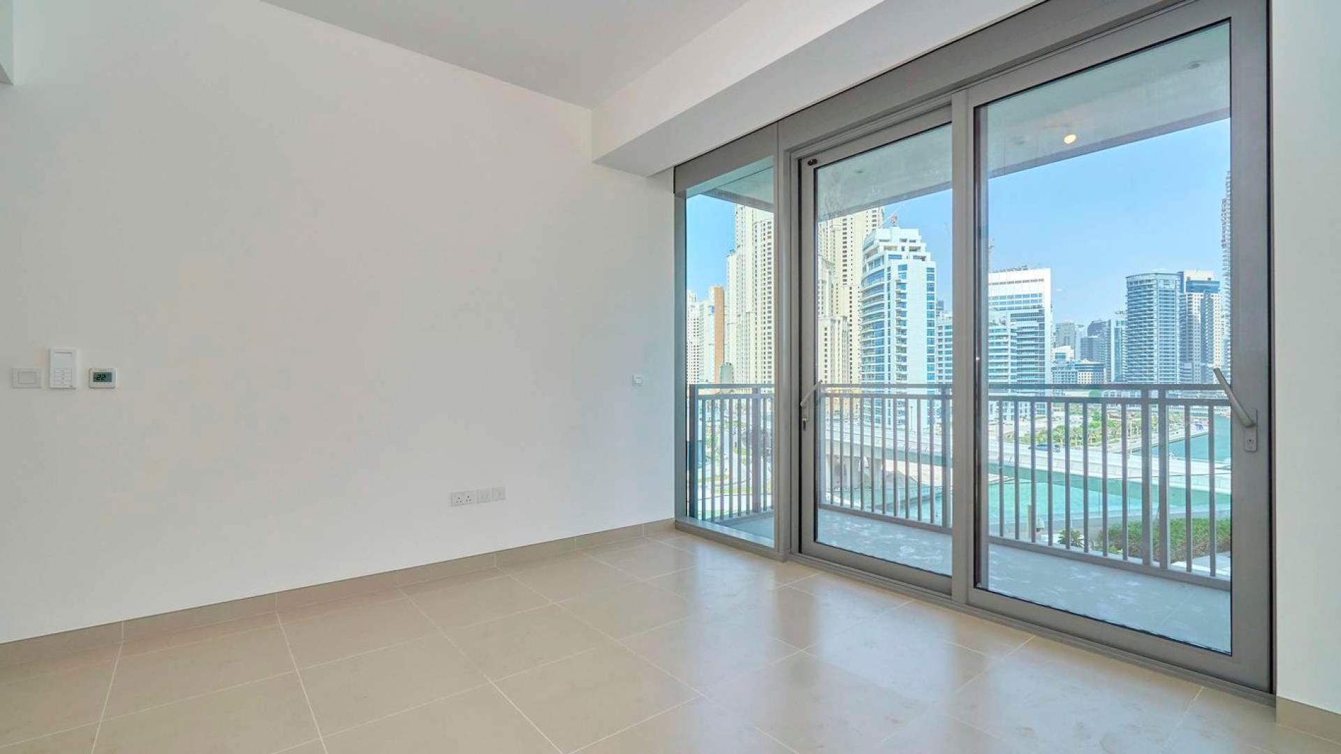 "Modern Dubai Marina apartment view with waterfront and cityscape, perfect for rent seekers.",Brand new Dubai Marina apartment with balcony view of skyline and waterfront