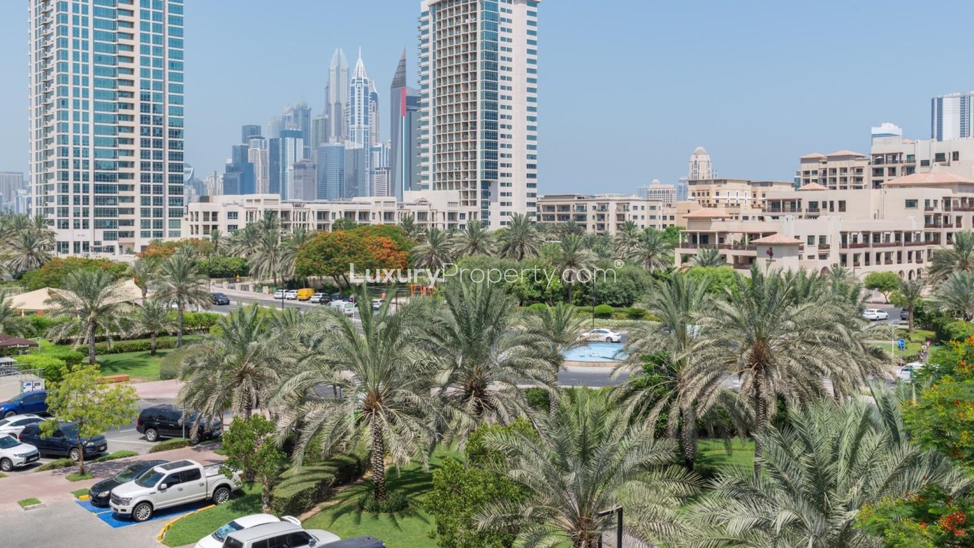 Fully-furnished living room in 1-bedroom apartment, The Greens, Al Dhafra, with park views