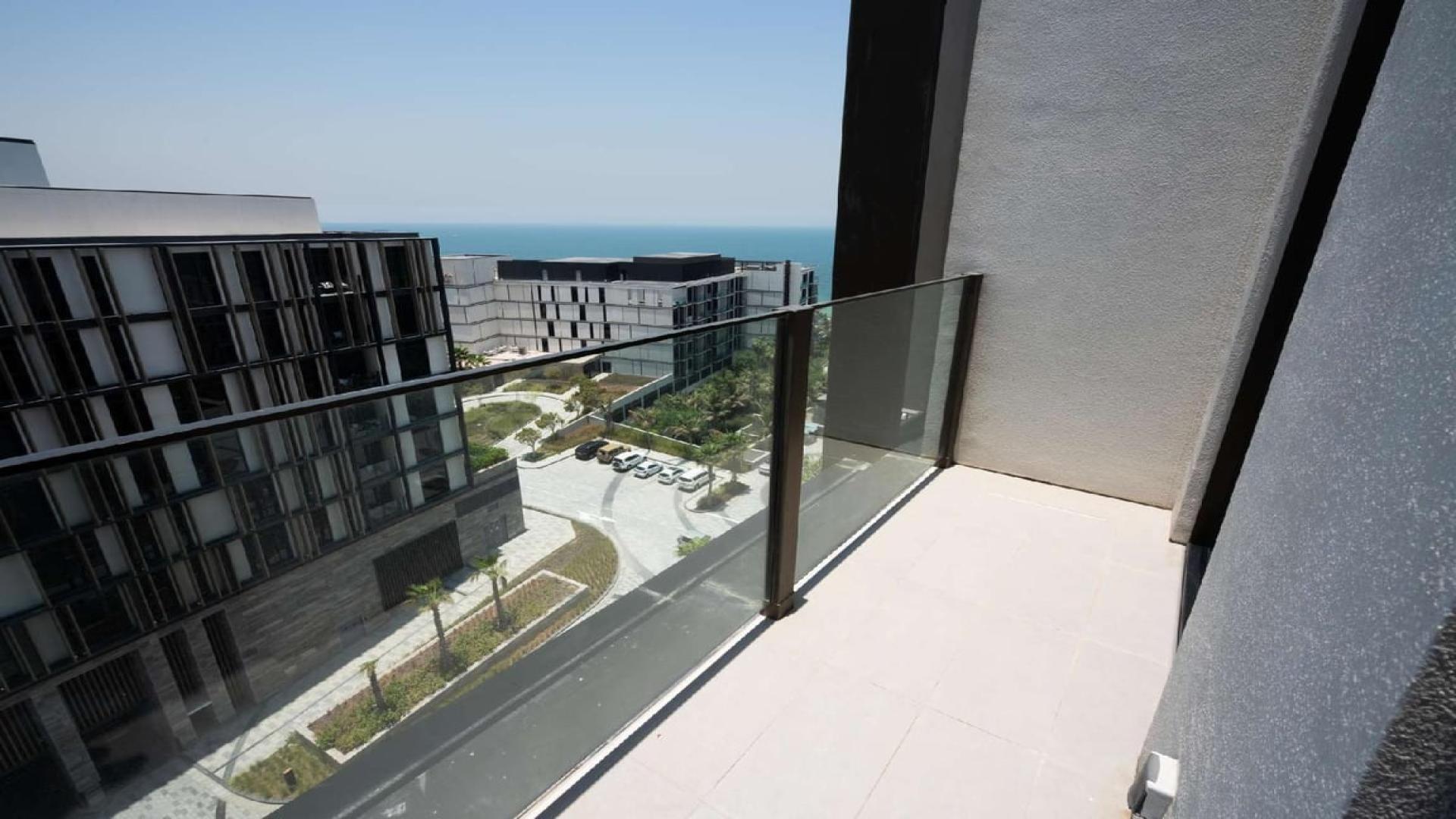 Modern kitchen in furnished apartment at Caesars Bluewaters Dubai, with sleek design and lighting